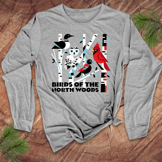 Gray long-sleeve shirt with 'Birds of the North Woods' design on a wooden surface.