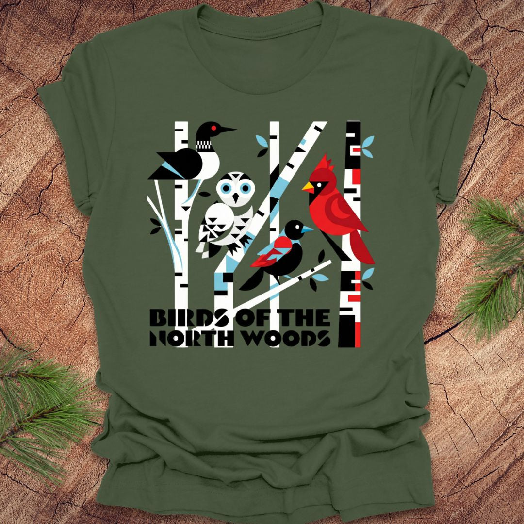 Green t-shirt with bird design and 'Birds of the North Woods' text on a wooden background