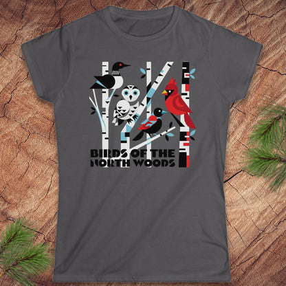 Gray t-shirt with nature-themed design featuring birds and trees on a wooden surface.