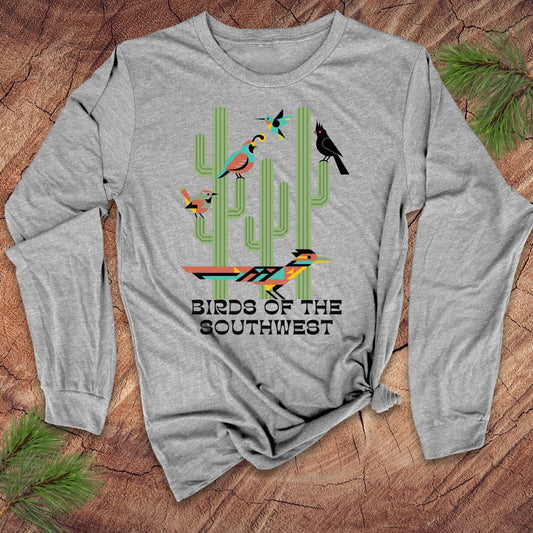Gray long-sleeve shirt with 'Birds of the Southwest' design featuring cacti and birds on a wooden surface.