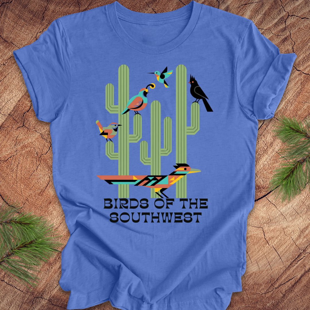 Blue t-shirt with cactus and bird design on a wooden surface