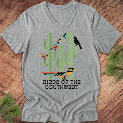 Gray t-shirt with text, 'birds of the southwest' and cactus on a wood background.