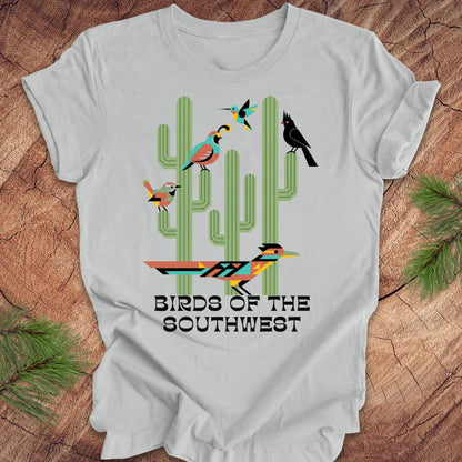 Gray t-shirt with 'Birds of the Southwest' design featuring cacti and birds on a wooden surface.