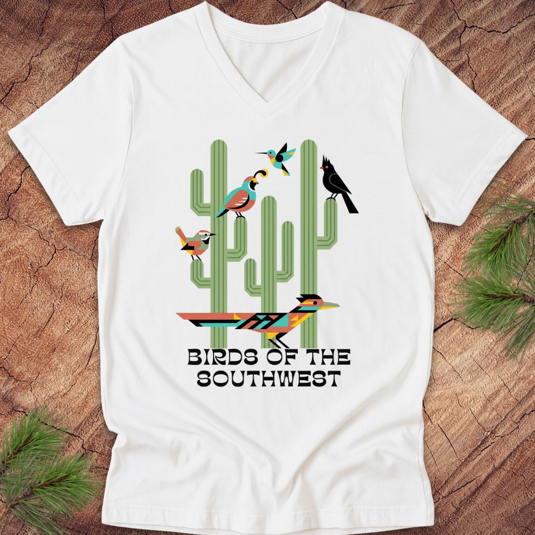 White t-shirt with text, 'birds of the southwest' and cactus on a wood background.