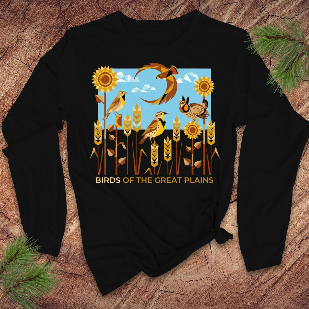 Black long-sleeve shirt with 'Birds of the Great Plains' design on a wooden surface.