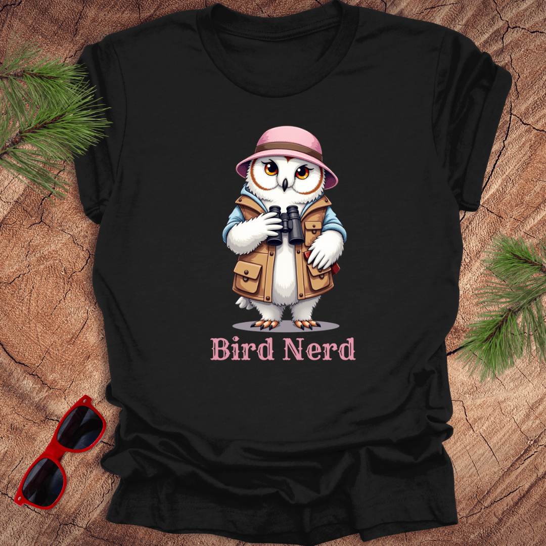 Black t-shirt with an animated snowy owl in birdwatching gear with "bird nerd" text on a wood background.
