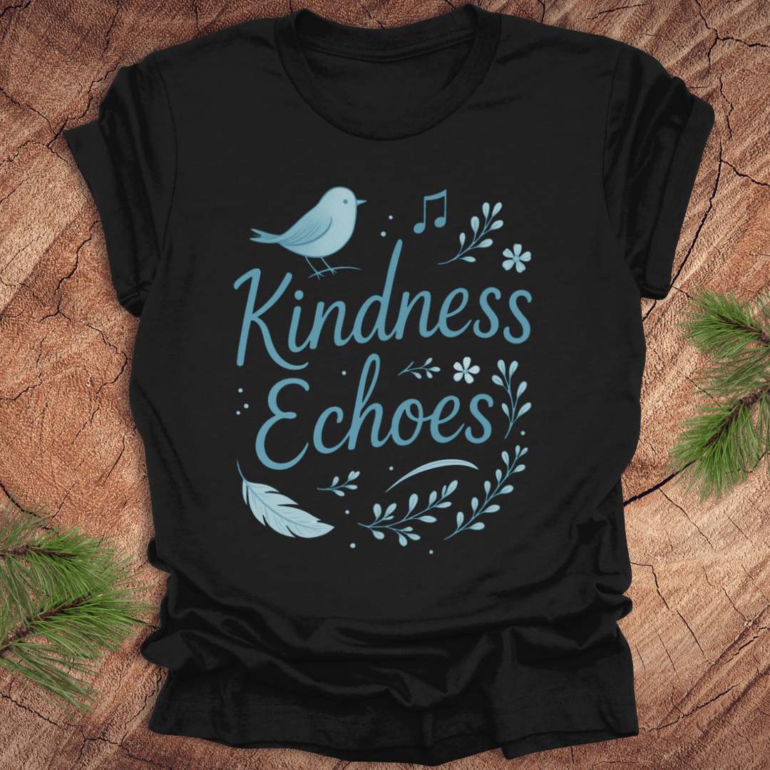 Black t-shirt with birds and flowers and text, 'Kindness Echoes' design on a wooden surface.