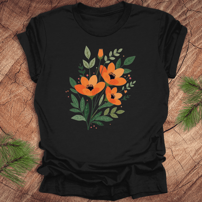 Black t-shirt with orange floral design on a wooden surface