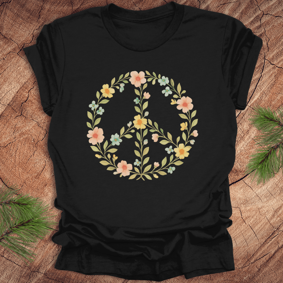 Black t-shirt with a peace sign made of flowers on a wood background.