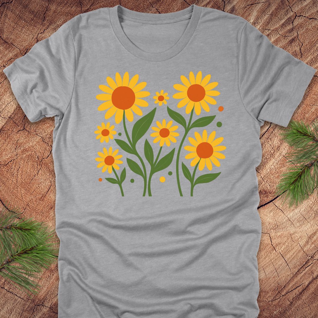 Gray t-shirt with yellow sunflower design on a wooden surface