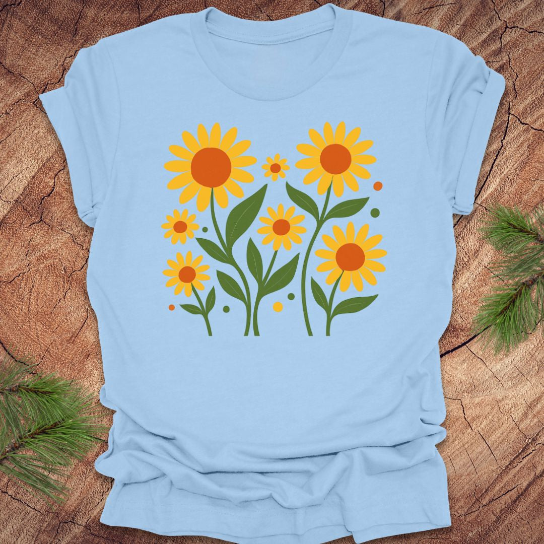 Light blue t-shirt with yellow sunflower design on a wooden surface