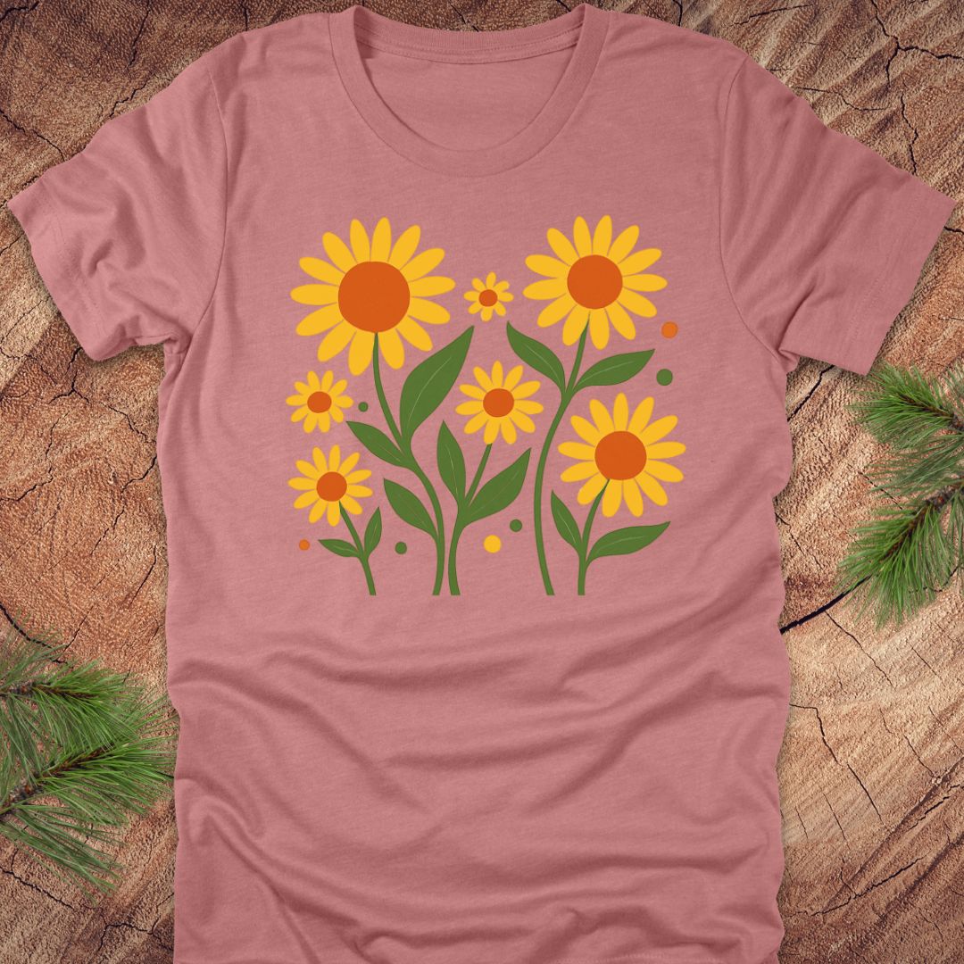 Mauve t-shirt with yellow floral design on a wooden surface