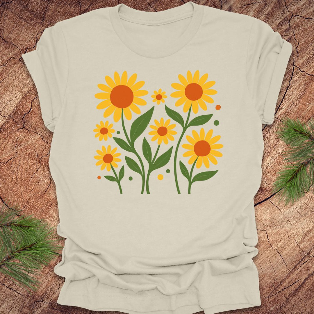 Beige t-shirt with sunflower design on a wooden surface