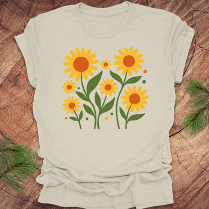 Beige t-shirt with sunflower design on a wooden surface