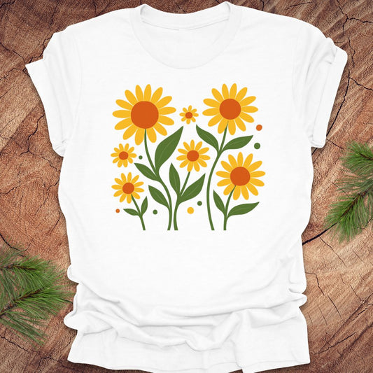 White t-shirt with yellow floral design on a wooden surface