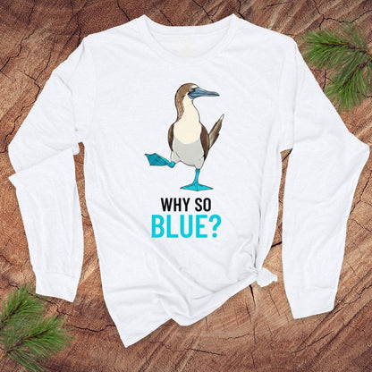 White long-sleeve shirt with a blue-footed booby bird graphic and 'Why So Blue?' text on a wooden surface.