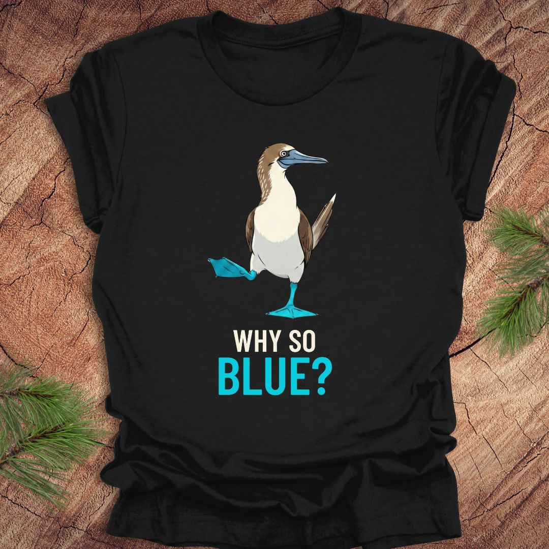 Black t-shirt with a blue-footed booby bird graphic and 'Why So Blue?' text on a wooden surface.