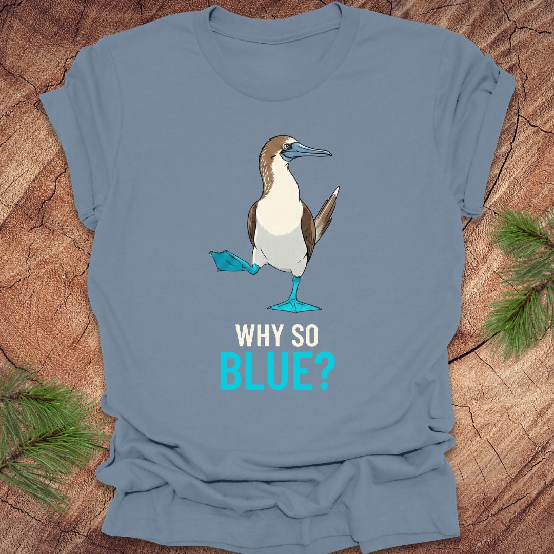 Blue t-shirt with a blue-footed booby bird graphic and 'Why So Blue?' text on a wooden surface.