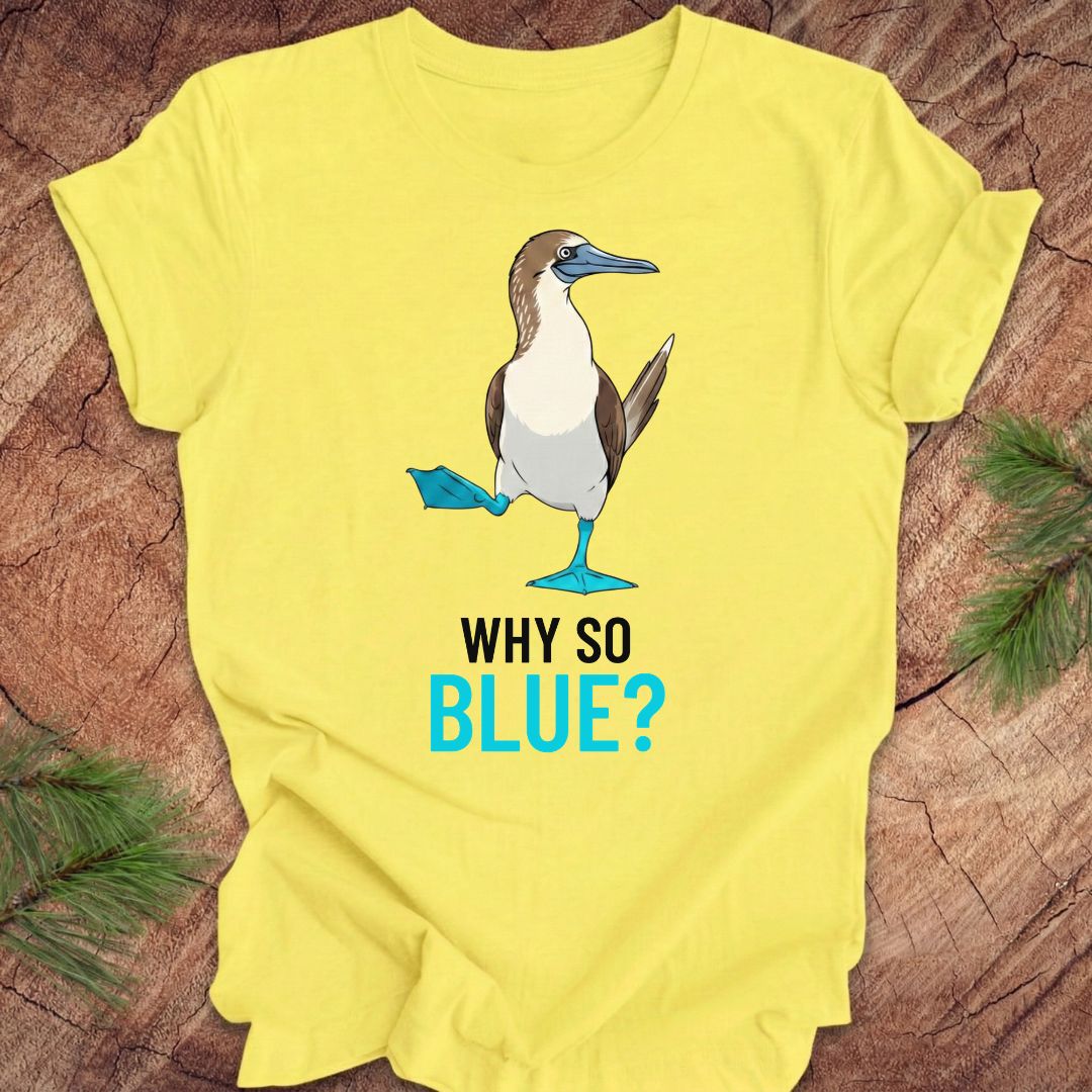 Yellow t-shirt with a blue booby graphic and 'Why So Blue?' text on a wooden surface.