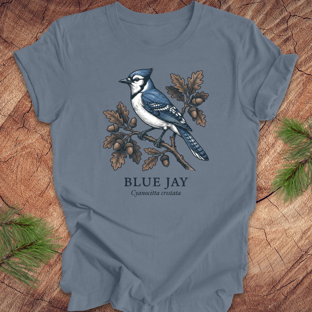 Blue t-shirt with a blue jay illustration on a wooden surface