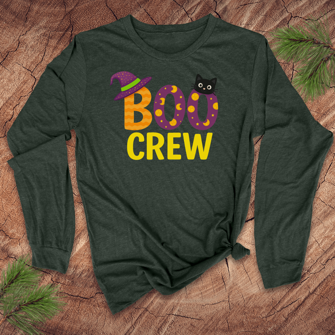 Green long-sleeve shirt with 'BOO CREW' text and cat graphic on a wooden surface.