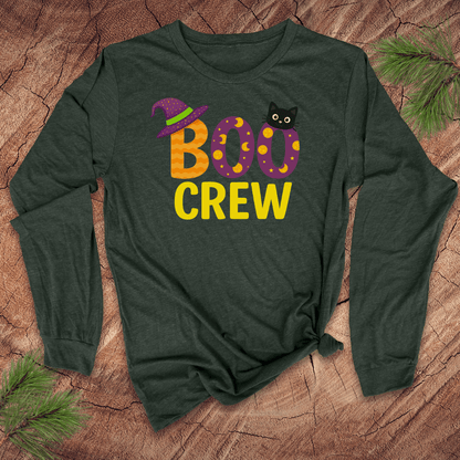 Green long-sleeve shirt with 'BOO CREW' text and cat graphic on a wooden surface.