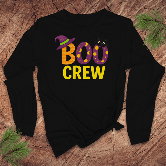 Black long sleeve tshirt with 'BOO CREW' text and witch hat graphic on a wooden surface.