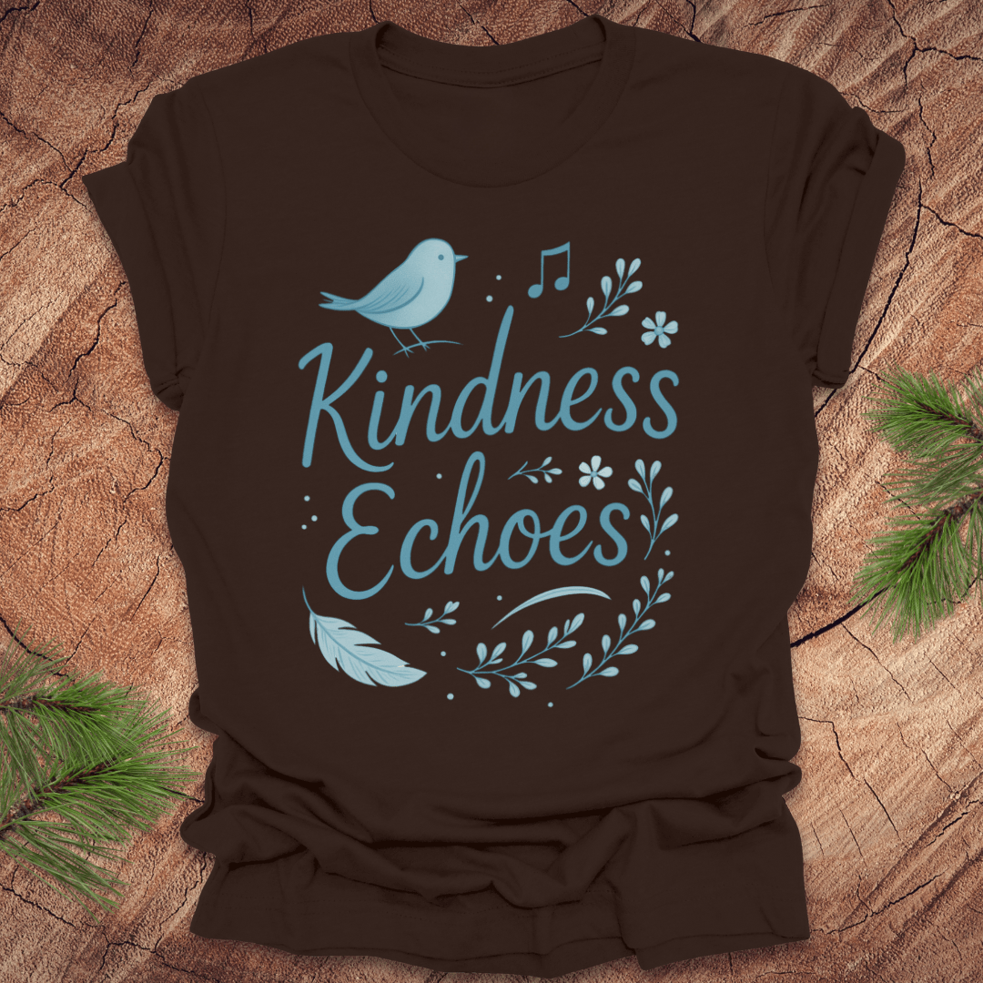 Brown t-shirt with birds and flowers and text, 'Kindness Echoes' design on a wooden surface.