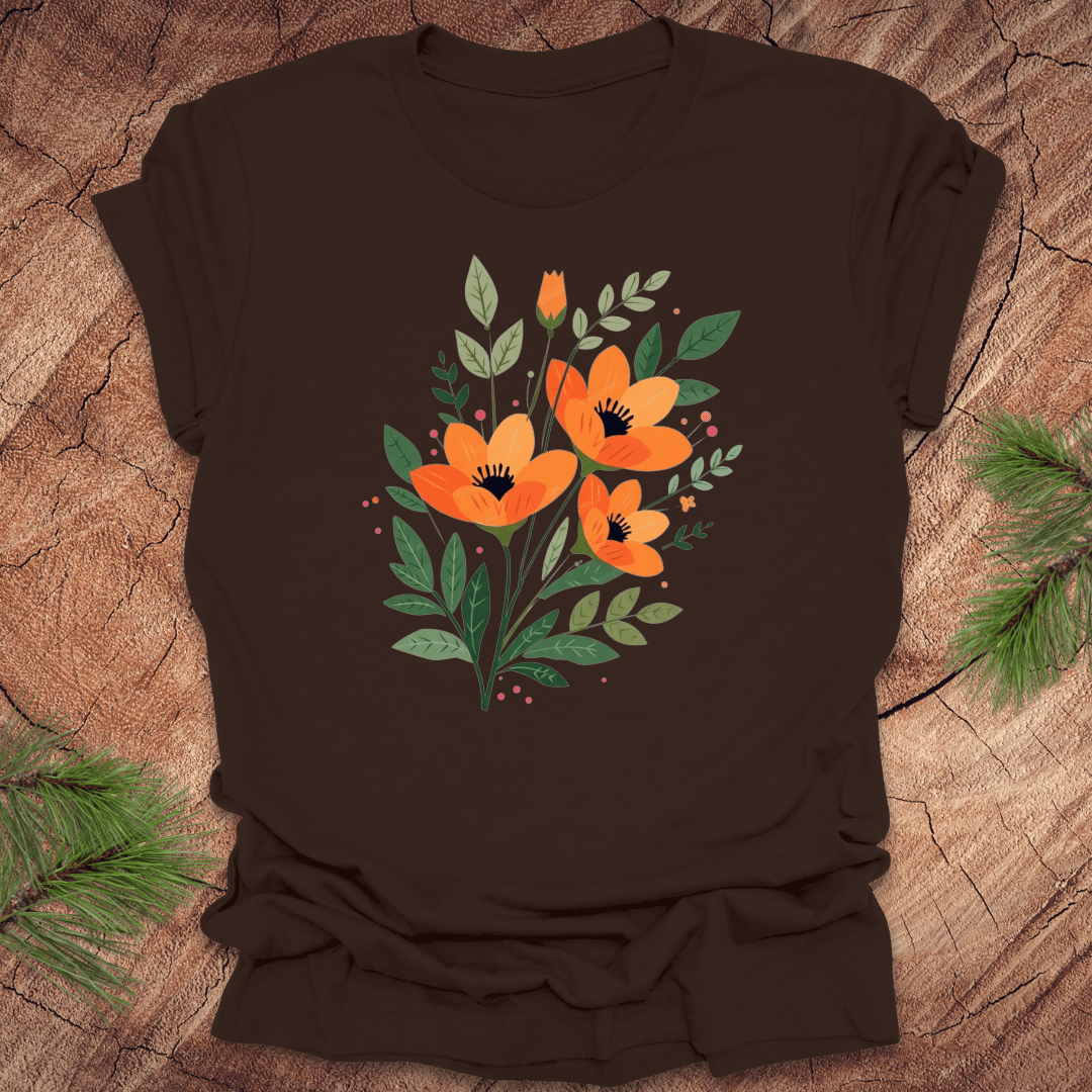 Brown t-shirt with orange floral design on a wooden surface