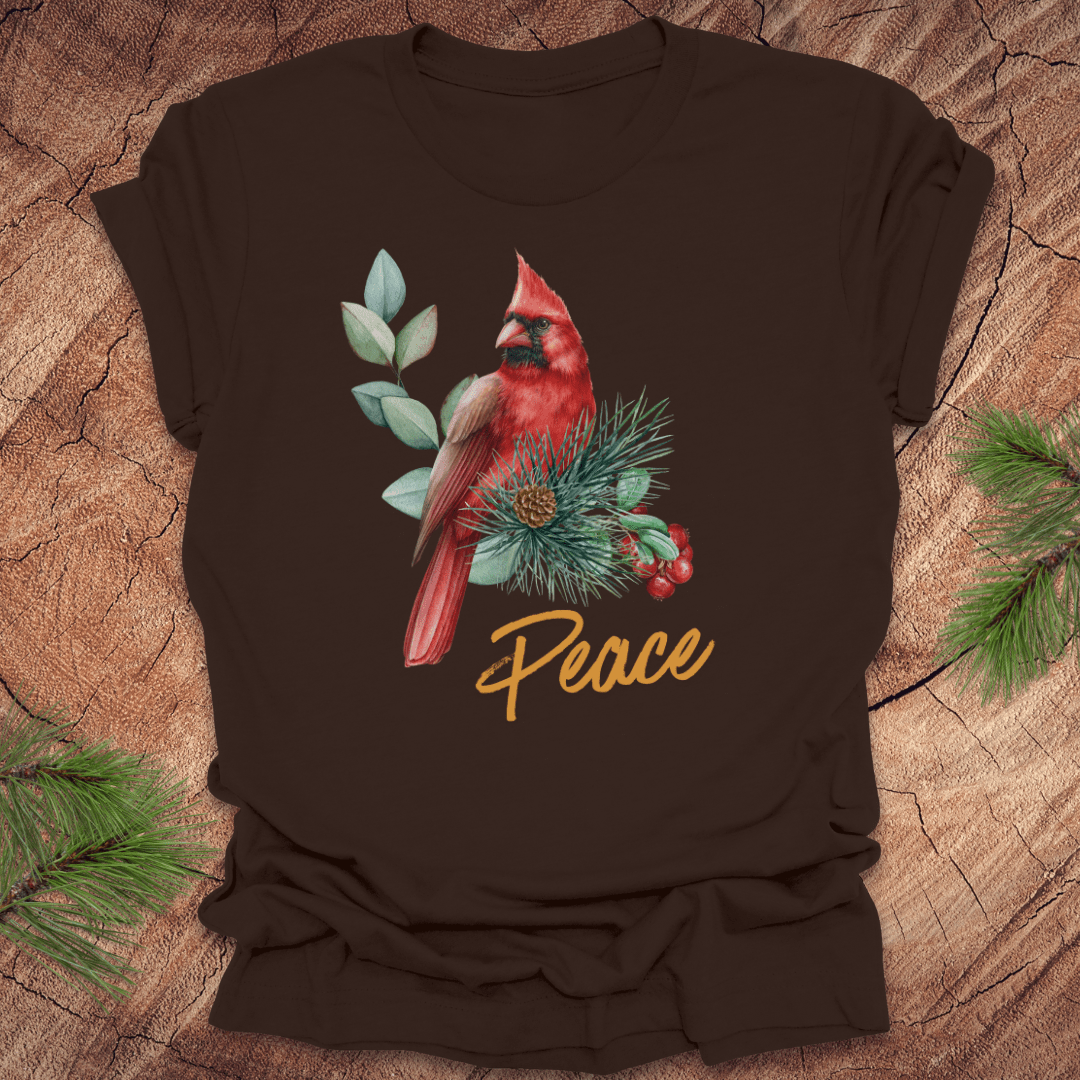 Brown t-shirt with a red cardinal and 'Peace' text on a wooden surface