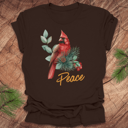 Brown t-shirt with a red cardinal and 'Peace' text on a wooden surface