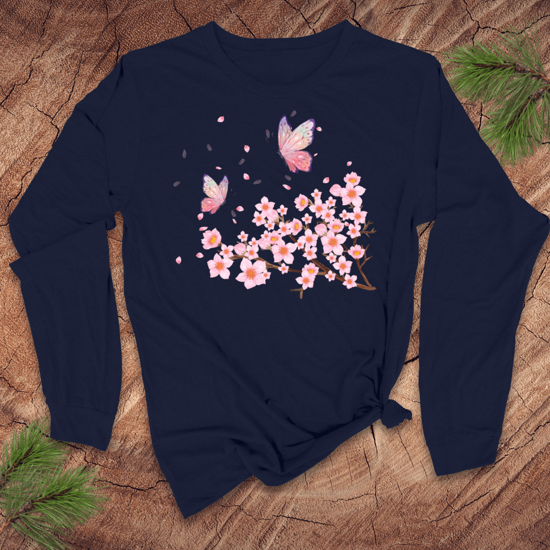 Navy blue long-sleeve shirt with pink cherry blossom and butterfly design on a wooden surface.