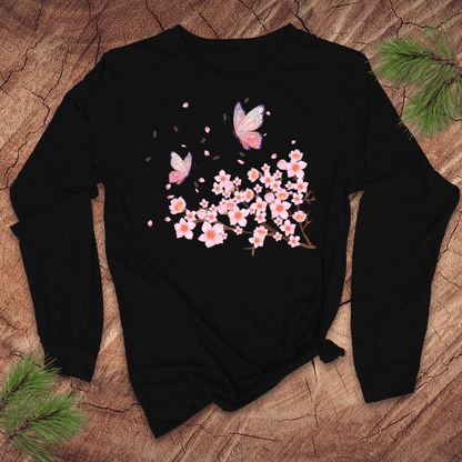 black blue long-sleeve shirt with pink cherry blossom and butterfly design on a wooden surface.