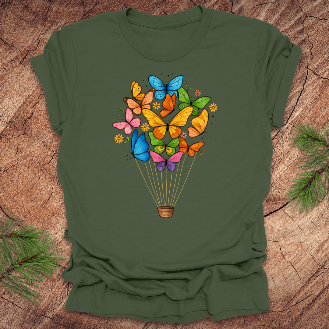 Green t-shirt with colorful butterfly design on a wooden surface