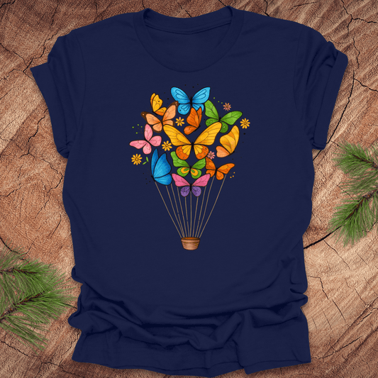 Navy blue t-shirt with colorful butterfly design on a wooden surface