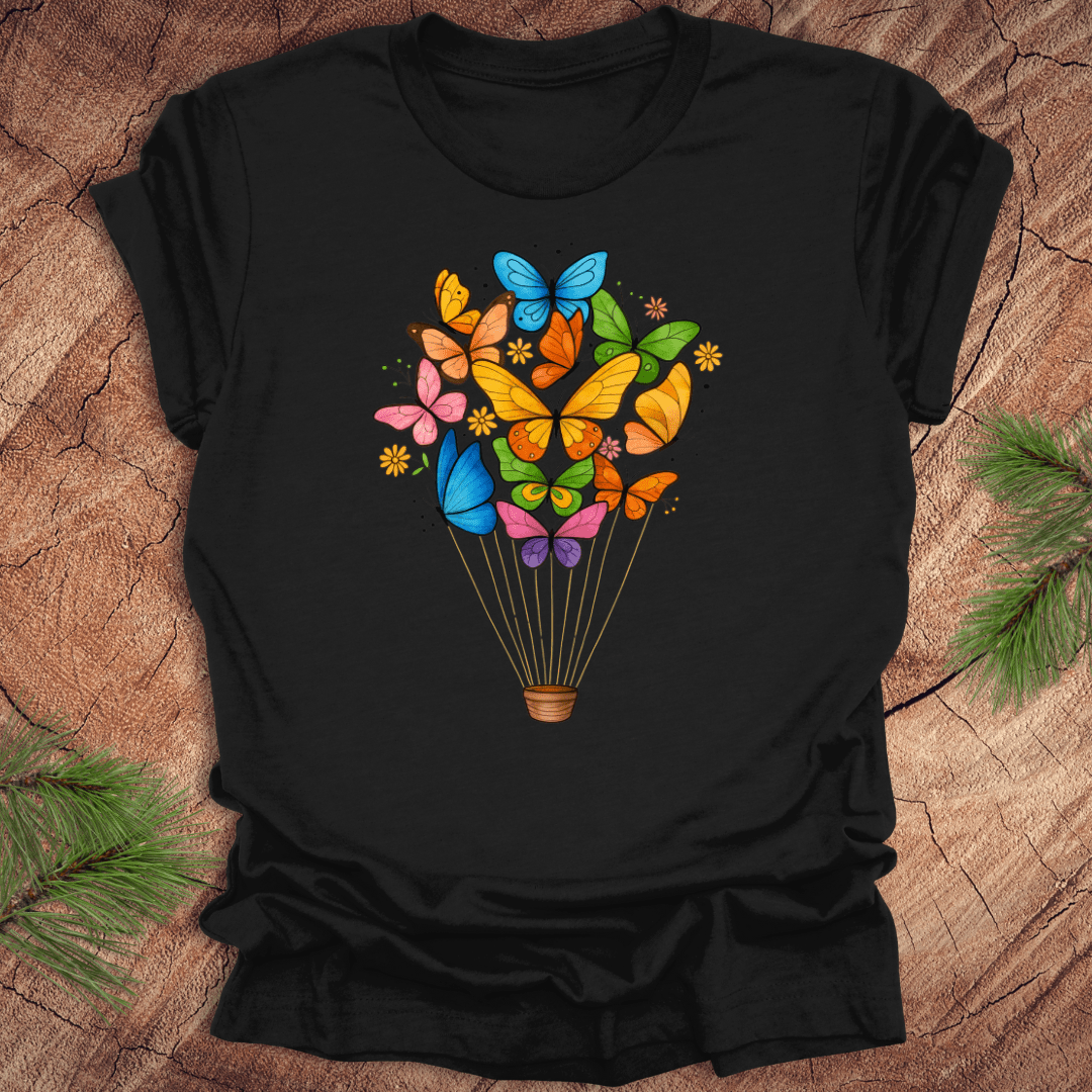 Black t-shirt with colorful butterfly design on a wooden surface