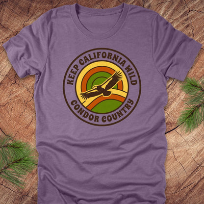 Purple t-shirt with 'Keep California Wild Condor Country' graphic on a wooden surface.