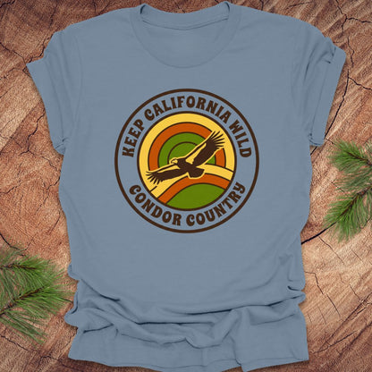Steel blue t-shirt with 'Keep California Wild Condor Country' graphic on a wooden surface.
