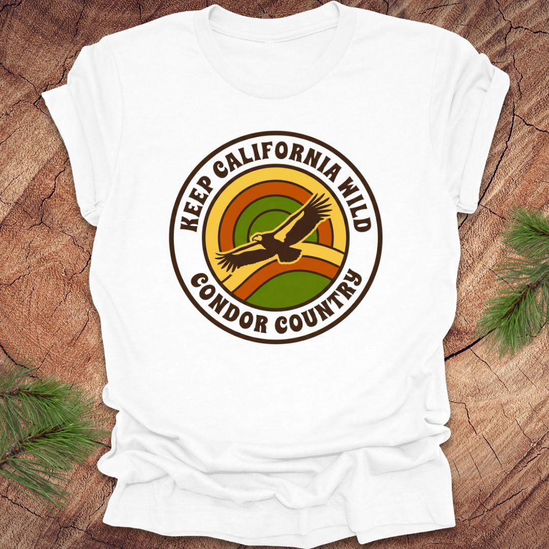 White t-shirt with 'Keep California Wild Condor Country' graphic on a wooden surface.