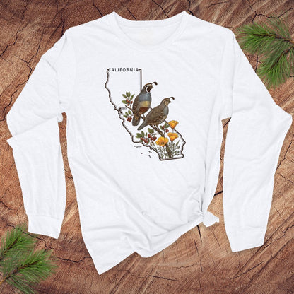 White long-sleeve shirt with California map and quail and poppies design on a wooden surface