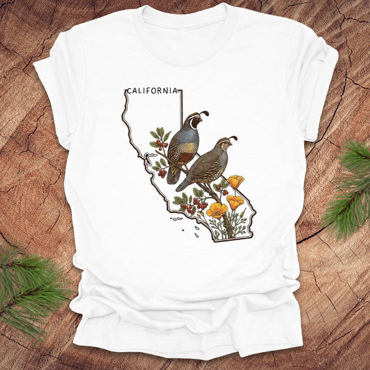 White t-shirt with California map and  quail and poppy design on a wooden surface