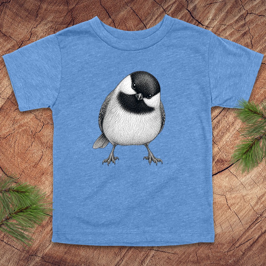 Blue toddler t-shirt with a chickadee design on a wooden surface