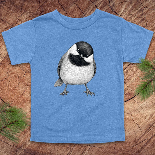 Blue toddler t-shirt with a chickadee design on a wooden surface