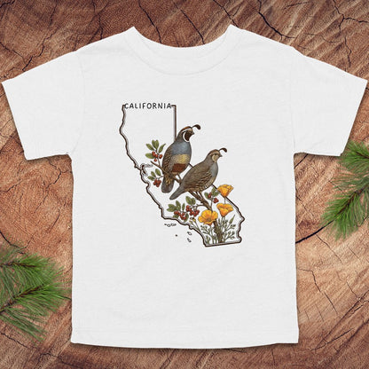 White toddler t-shirt with state outline of California and quails and flowers on a wood background.