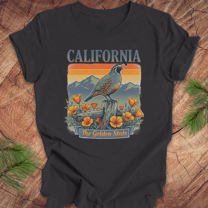 Dark gray t-shirt with California-themed design featuring a quail, mountains, and poppies on a wooden surface.