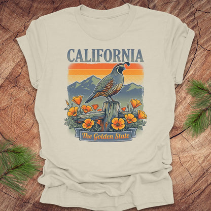 Beige t-shirt with California-themed design featuring a parrot and poppies on a wooden surface.