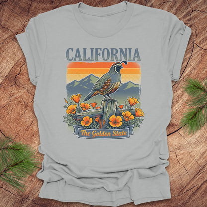 Gray t-shirt with California-themed graphic featuring a quail and poppies on a wooden surface.