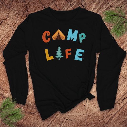 Black long sleeve tshirt with 'CAMP LIFE' text on a wooden surface with pine branches.