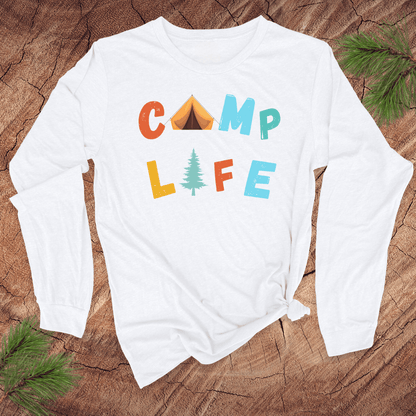 White long-sleeve shirt with 'CAMP LIFE' text and camping-themed graphics on a wooden surface.