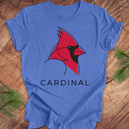 Blue t-shirt with a cardinal and text on a wood background.